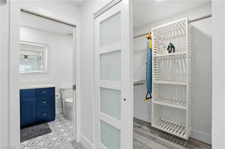 Bathroom with vanity and light wood-style floors - Virtually Edited Image