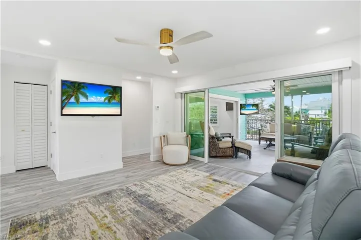 Living room with ceiling fan, wood finished floors, and recessed lighting - Virtually Edited Image