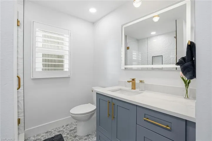 Bathroom featuring vanity, a shower stall, and recessed lighting - Virtually Edited Image