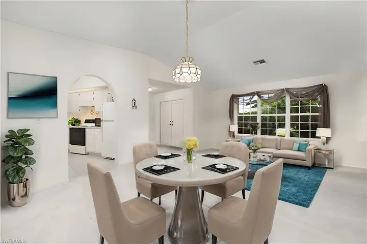 Dining space and family room featuring lofted ceiling ** Virtually Staged**