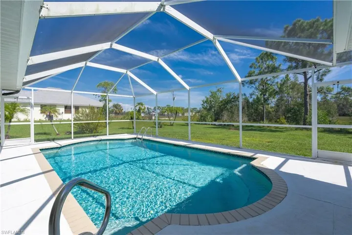 View of pool featuring a patio area, a lanai, and a yard