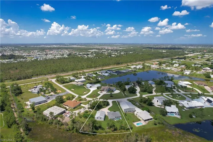 Drone / aerial view featuring a water view and runway