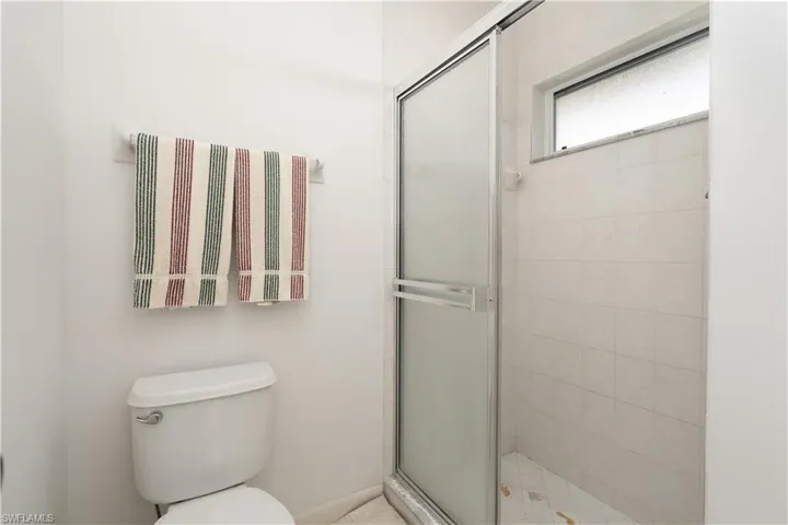 Bathroom with a shower with shower door and toilet