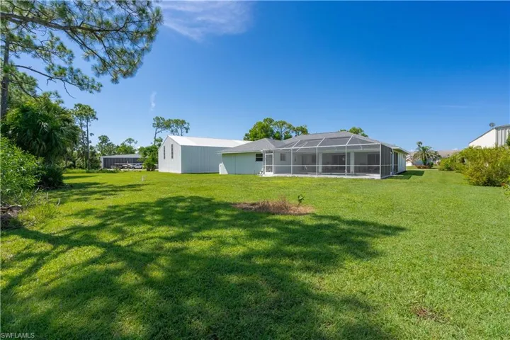 View of yard featuring glass enclosure