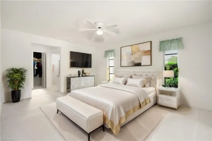 Virtually Staged Bedroom featuring ceiling fan, a walk in closet, and a closet** Virtually Staged**
