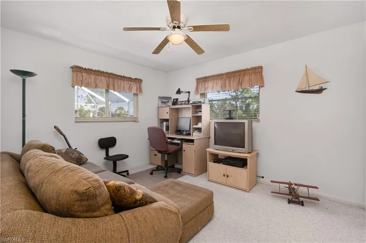 Carpeted living room featuring ceiling fan** Virtually Staged**