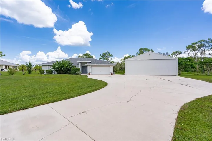 Ranch-style home with a garage and a front yard