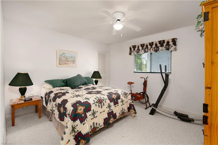 Bedroom featuring ceiling fan and carpet