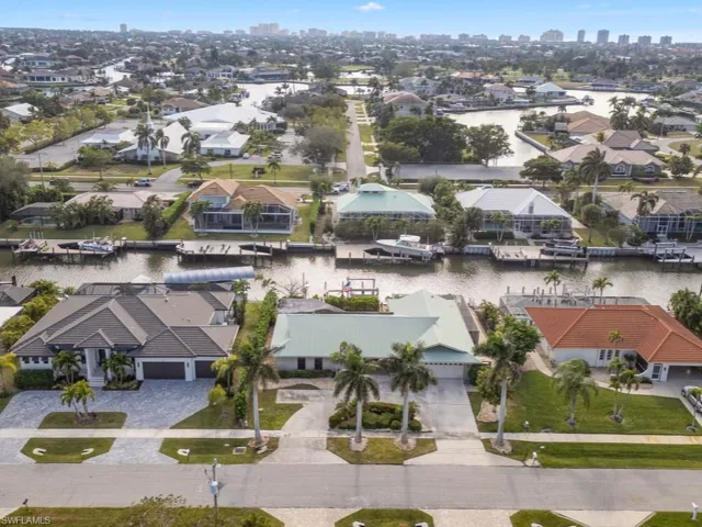 Birds eye view of property with a water view