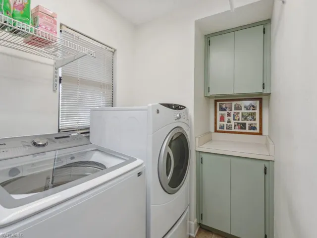 Laundry area featuring cabinets and independent washer and dryer