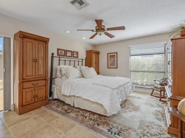 Tiled bedroom with a textured ceiling and ceiling fan