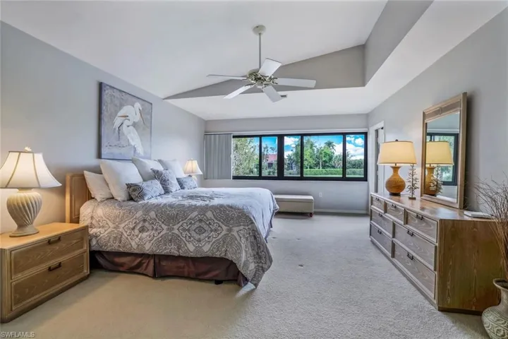 Primary Suite- Approx 19' x 14' Cream Carpet, Raised Ceiling, Door to Lanai- Room Darkening Honey Comb Blinds