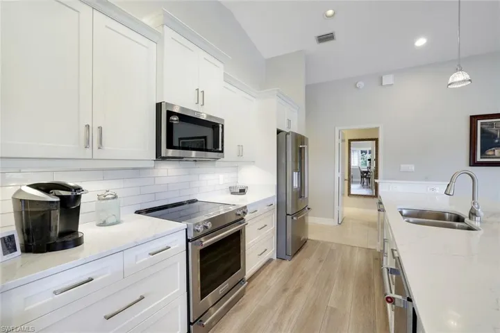 Real Wood, Soft Close, Wide Handle, Cabinets, Quartz Water Fall Counter Tops, Glass Tile Backsplash