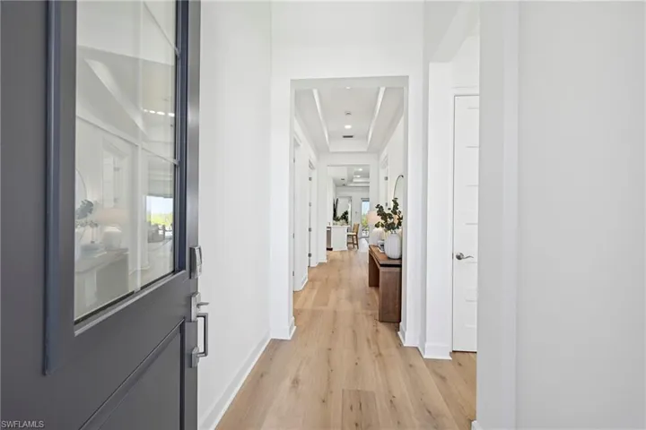 Entry foyer featuring a dark gray paneled door with glass inserts and dark hardware