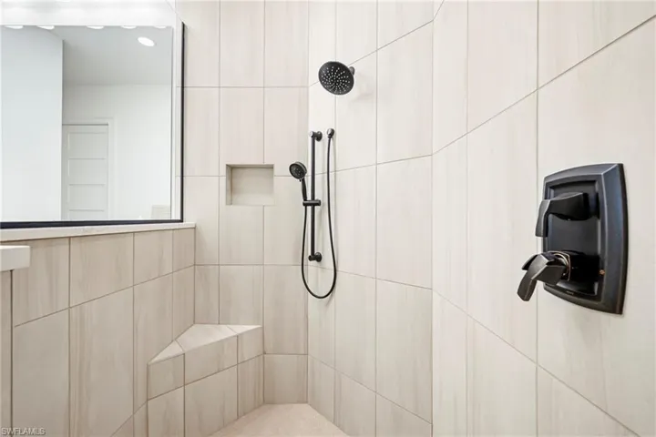 Shower enclosure with light-toned rectangular tilework