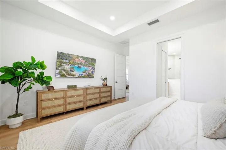 Bright room featuring light wood-finish flooring and recessed lighting