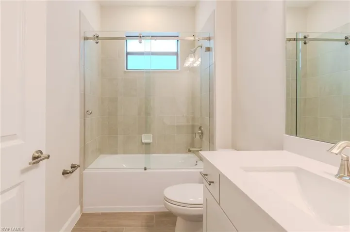 Unfurnished bedroom with ornamental molding, wood tiled floors, a closet, and ceiling fan