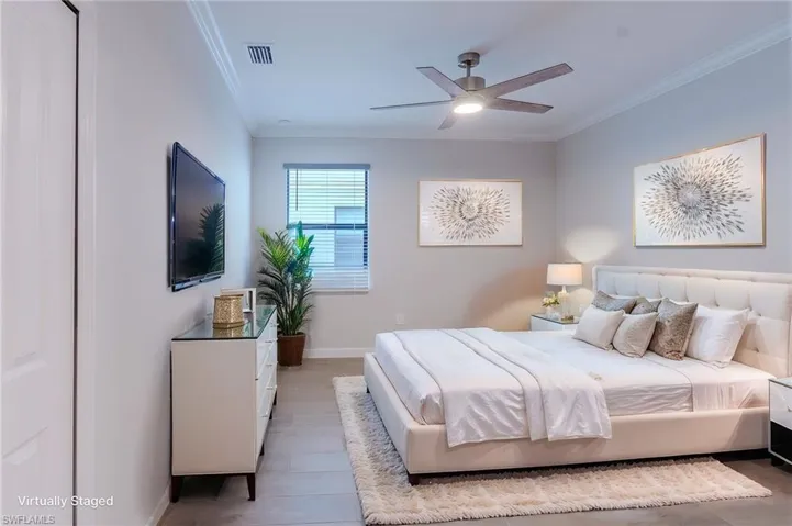 Unfurnished bedroom with ornamental molding, wood tiled floors, a closet, and ceiling fan