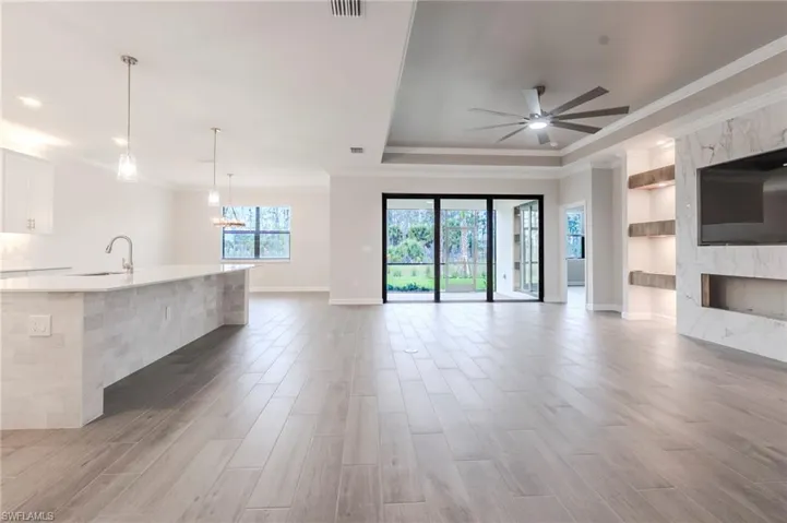 Dining space featuring wood finished floors, ornamental molding, and a chandelier