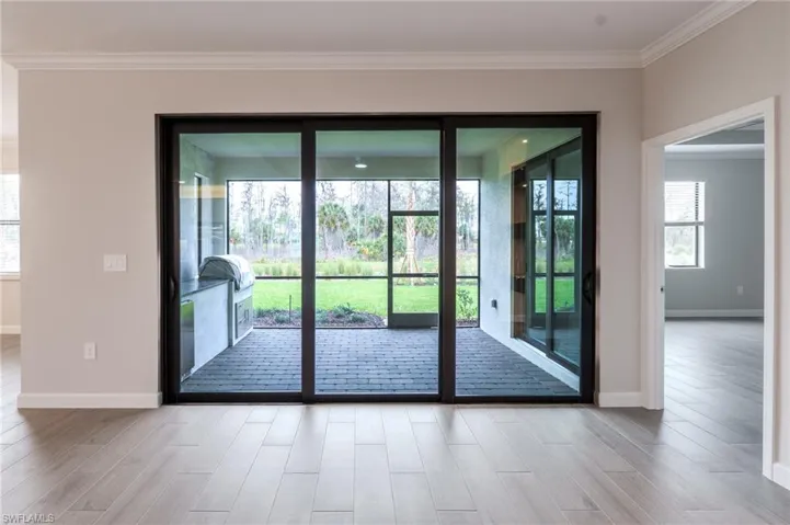 Unfurnished sunroom featuring exterior kitchen