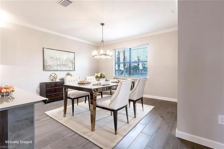 Unfurnished living room featuring built in features, ornamental molding, suspended lighting, a premium fireplace, and dark wood-style floors