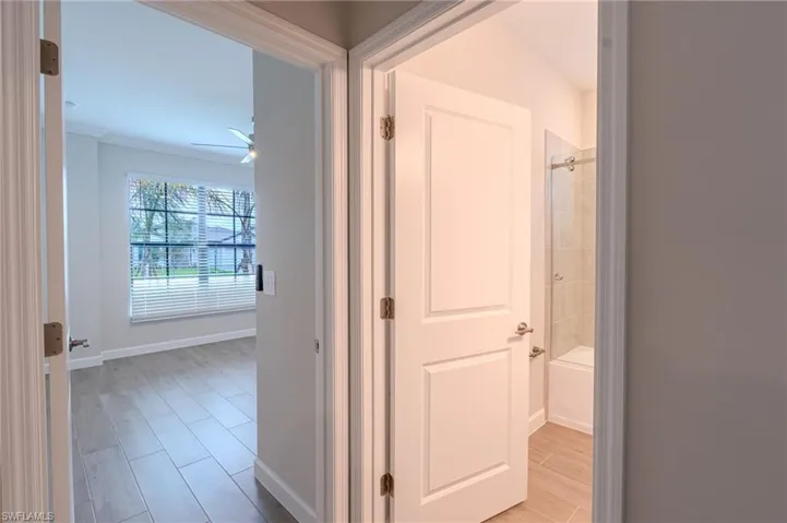 Hall with wood tiled floors and crown molding