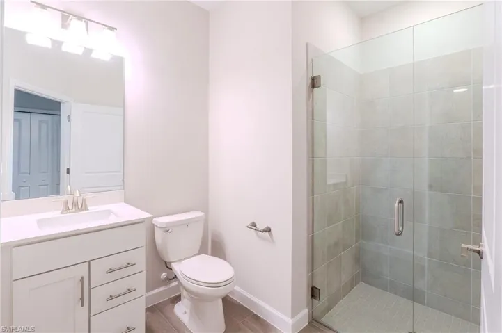 Corridor with crown molding and light wood finished floors