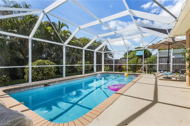 Swimming pool with a lanai, a patio area, and a sunroom