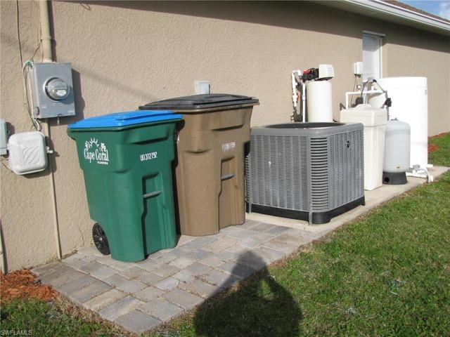 Nicely organized equipment and trash on paver surface.