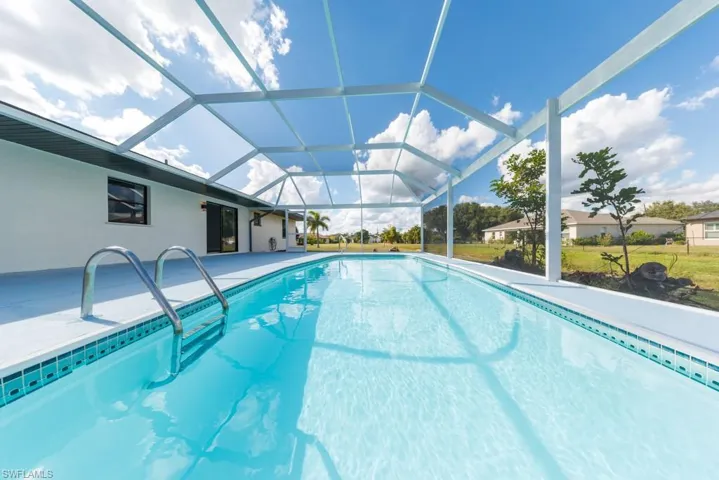 Sparkling pool with brand-new screened enclosure, perfect for family fun and relaxation