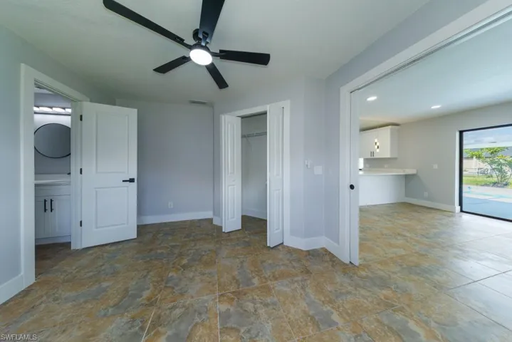 Spacious primary suite with ensuite bath and convenient pocket door access to the light-filled breakfast nook overlooking the pool.