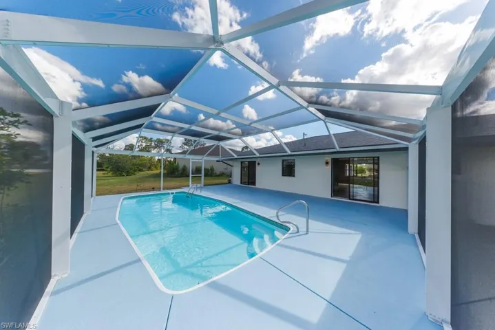 Spacious screened pool with easy indoor access, perfect for relaxing or entertaining