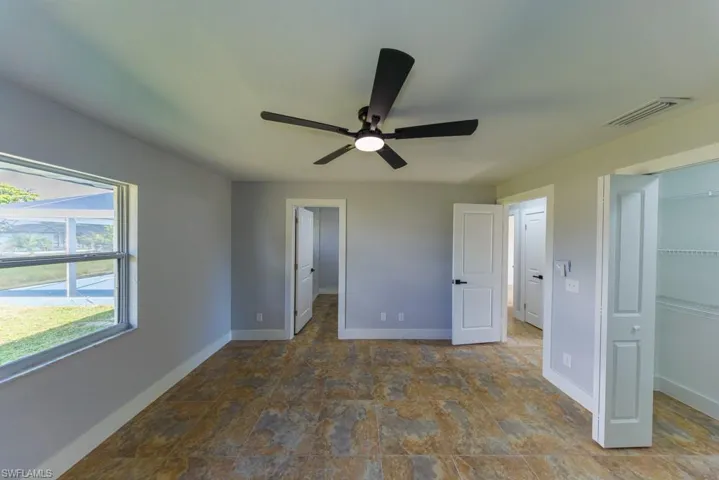 Inviting second master suite with ensuite bathroom, tile floors, and a relaxing atmosphere, great for guests or multigenerational living.
