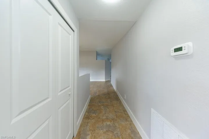 Bright hallway with elegant tile flooring and fresh finishes.