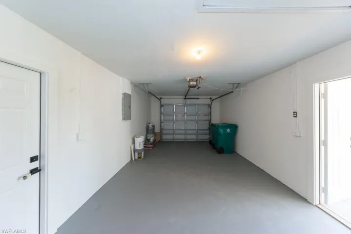 Clean and bright garage with bonus side entrance for flexibility and function.