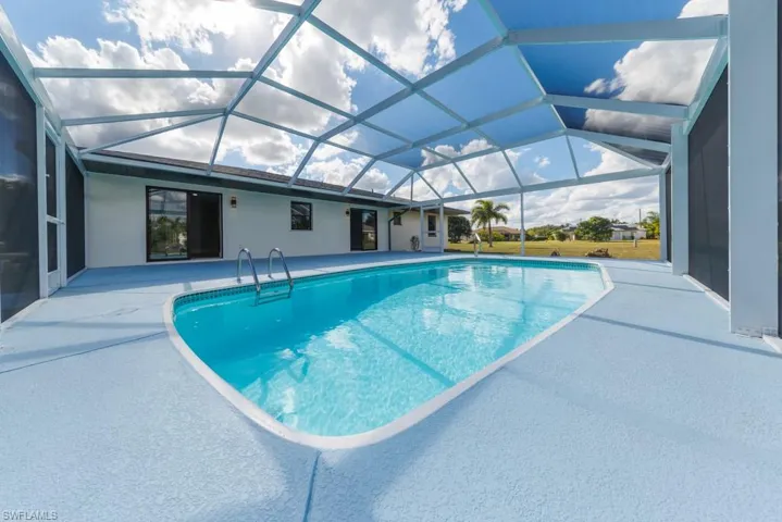 Inviting screened pool with brand-new enclosure and spacious deck for relaxing or entertaining.