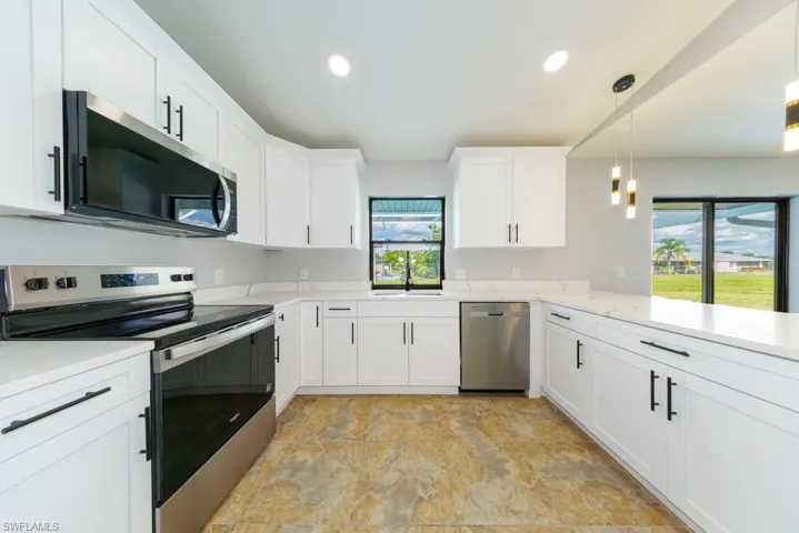 Stylish kitchen featuring quartz countertops, recessed lighting, and a spacious layout.