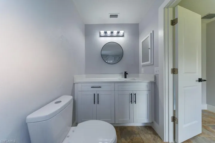 Beautifully updated ensuite bathroom featuring a walk-in shower with modern tile surround, sleek vanity with ample storage, and contemporary finishes throughout.