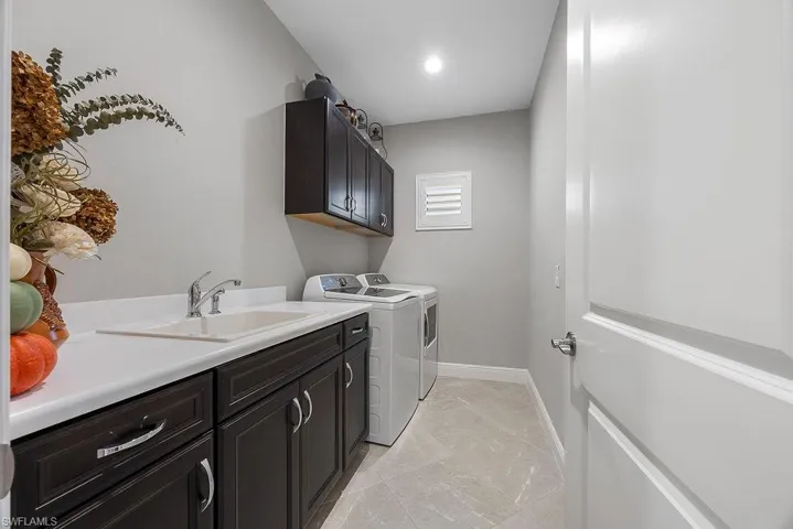 Laundry area with cabinet space, washing machine and clothes dryer, and recessed lighting
