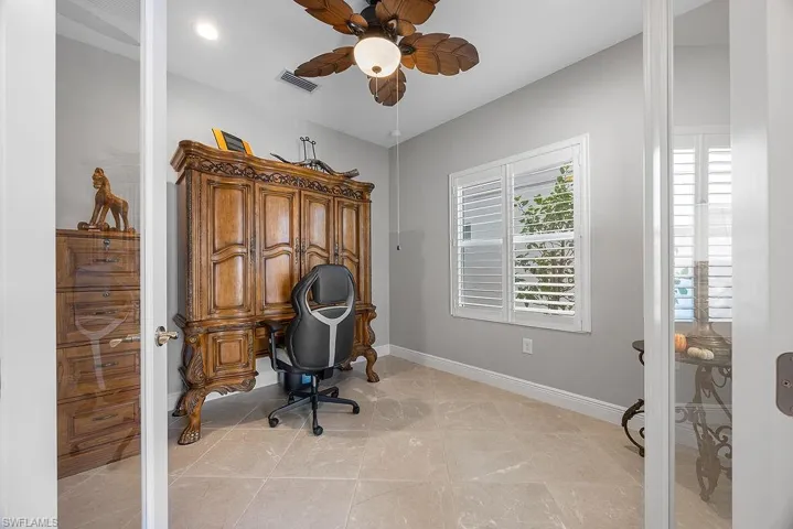 Home office featuring ceiling fan and light tile patterned floors