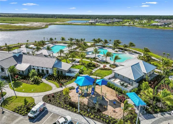 Drone / aerial view of a pool area and a nearby body of water