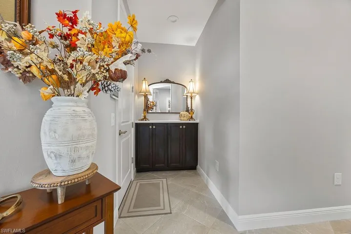 Bathroom featuring light tile patterned flooring and vanity