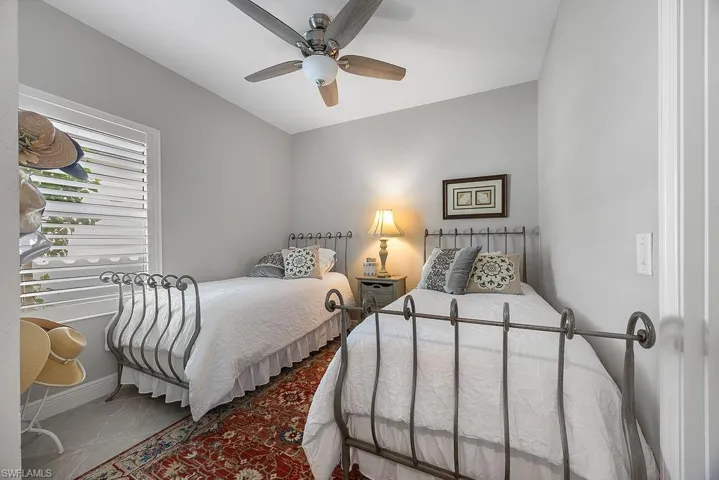 Bedroom with ceiling fan and tile patterned floors