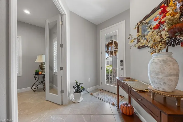 Doorway to outside featuring healthy amount of natural light and tile patterned flooring