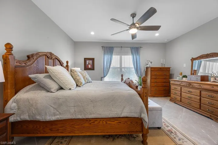 Bedroom featuring ceiling fan, recessed lighting, and light tile patterned flooring