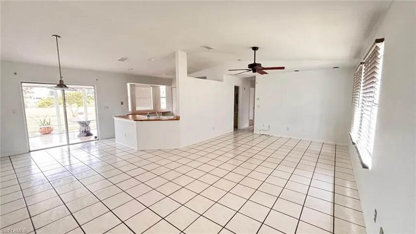 Main room with ceiling fan and light tile patterned floors