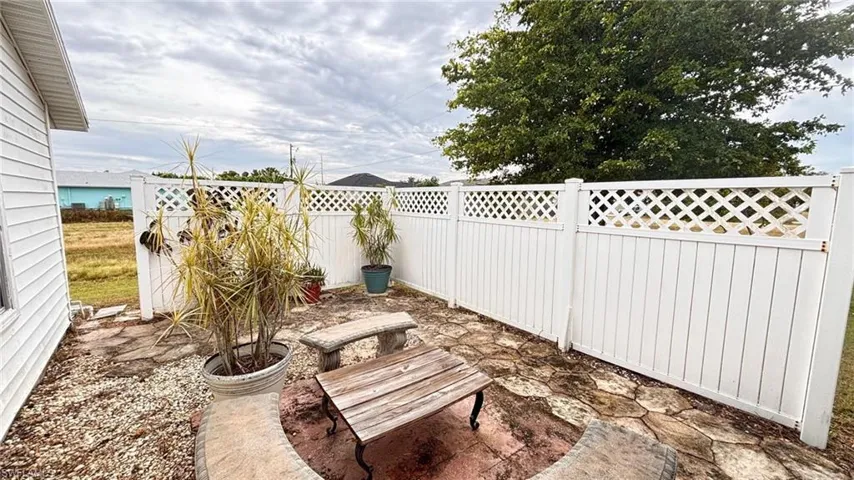 Fenced backyard with a patio