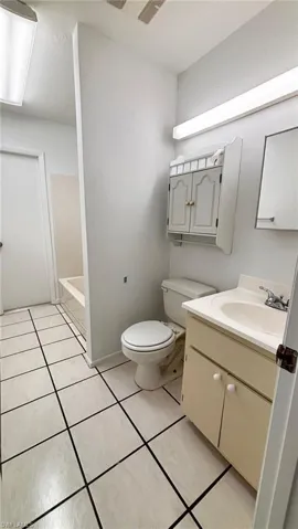Full bath featuring vanity and light tile patterned floors