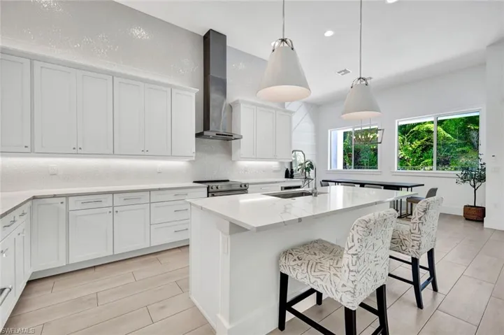 Notice such details as custom light fixtures, quartz countertops, large center island, stainless appliances and so much more!