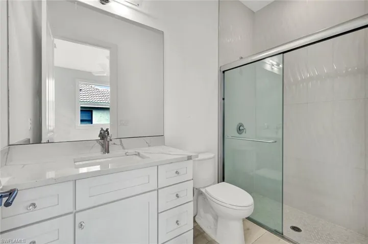 Ensuite guest bathroom features a walk-in shower.